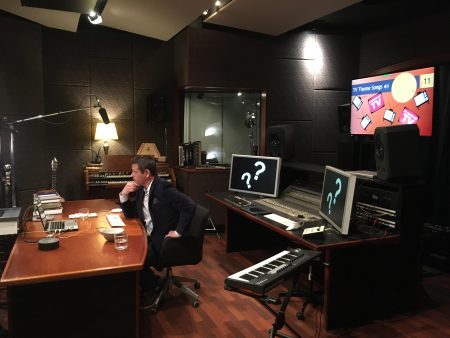 Man-in-suit-sitting-in-production-studio-for-virtual-event