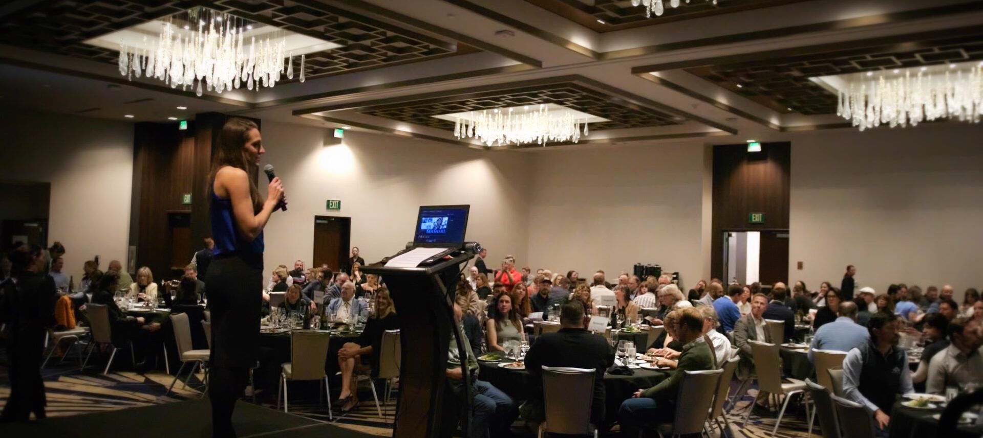 Seattle Corporate Event Auction Fundraiser Embassy Suites Ballroom Speaker at Podium